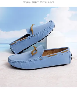 Close-up of light blue suede driving loafers featuring a brown decorative bow tie.