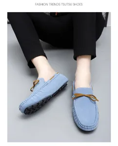 Close-up of light blue suede driving loafers with stylish brown ribbon detail