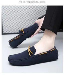 Detailed close-up of men's navy blue suede loafers with stylish yellow bow accents