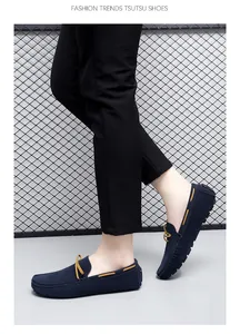 Side view detail of navy blue suede loafers with yellow accents for men
