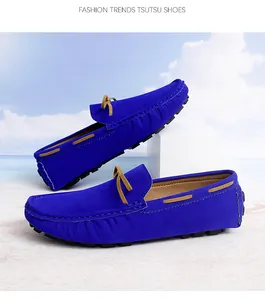 Close-up of vibrant blue suede loafers for men featuring classic tan lace detailing