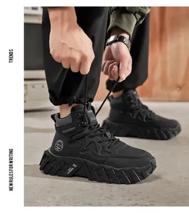 Detailed view of black mid-top microfiber work boots with rugged soles and laces