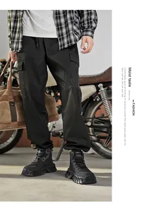 Men's black mid-cut outdoor Martin boots paired with street-style cargo pants and a motorcycle.