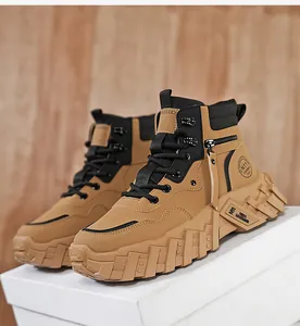 Side view detail of tan mid-top outdoor work boots with chunky lug soles