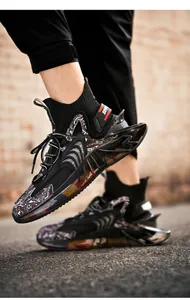 Detailed view of black mid-cut sock sneakers with stylish hollow blade sole design.