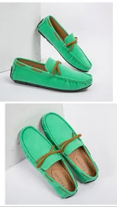 Close-up of green suede loafers for men with brown bow detail and soft sole
