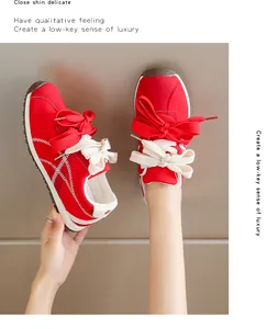 Trendy red suede sneakers for women with double bowknot laces for casual outdoor style.