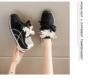 Detail shot of black suede sneakers with unique double shoelace design