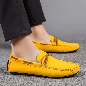 Bright yellow suede loafers for men with stylish bow detail and contrast stitching