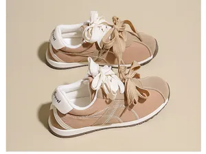 Close-up of suede sneakers showing unique double-lace design and 'Travel' heel detail