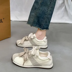 Stylish women's beige suede sneakers with thick laces for casual outdoor activities