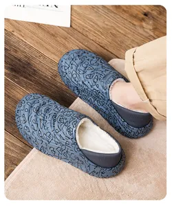 Detailed view of blue waterproof slippers with warm white fleece lining on a cozy rug.