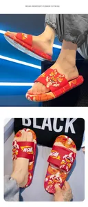 Gros plan de claquettes rouges pour hommes avec motif de dragon chinois traditionnel.
