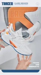 Detail view of white breathable mesh sneakers featuring unique blade sole and orange accents