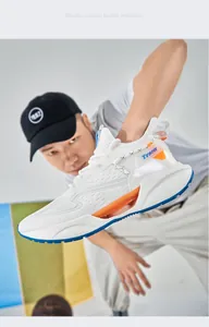 Close-up of white breathable mesh running shoes with vibrant orange accents
