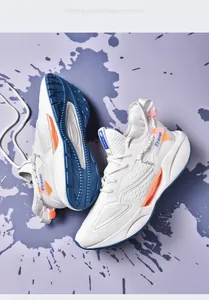 Macro detail view of white flyknit blade sneakers with blue soles and orange trim