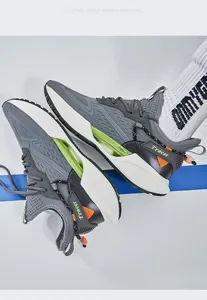 Close-up of men's stylish grey blade sole sneakers with vibrant neon green accents.