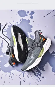 Detailed view of grey fly-knit men's athletic running shoes with blade sole design