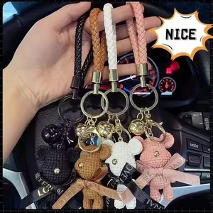 Detailed view of four colorful crochet bear keychains featuring braided straps and gold bells