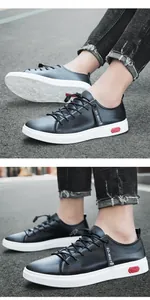 Close-up van zwarte echt leren casual sneakers met witte zolen op asfalt