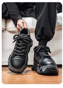 Detailed view of trendy black platform sneakers with thick wavy soles and rope laces