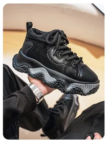 Detail view of men's black chunky sneakers with textured platform sole