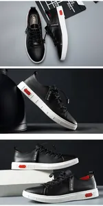 Gedetailleerde weergave van zwarte echt leren sneakers met witte zolen en rode accenten
