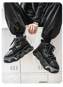 Close-up detail of black chunky streetwear bread shoes with thick wavy platform soles for men