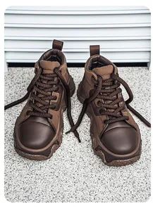 Detailed shot of brown chunky platform sneakers with thick laces and textured soles
