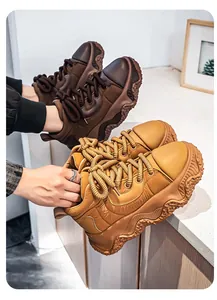 Detailed close-up of stylish men's chunky platform bread sneakers in brown and tan colors.
