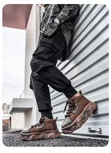 Detail view of stylish men's brown thick-soled platform sneakers in urban industrial setting