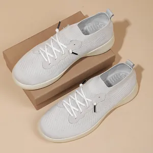 Breathable grey fly-knit running sneakers with thick cushioning sole for outdoor activities