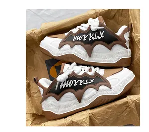 Detailed macro view of brown and white chunky bread sneakers with unique bat wing design
