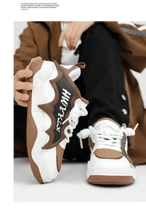 Detailed view of white and brown chunky sneakers with bat-wing design element.