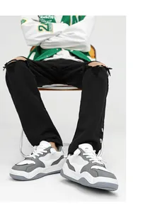 Stylish thick-soled sneakers paired with ripped jeans for a trendy streetwear look.