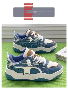 Side view of blue and white platform chunky sneakers displayed on a green textured mat
