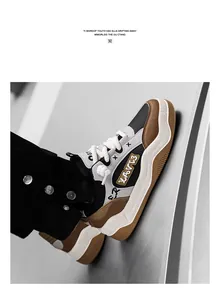 Close-up of chunky bread sneakers with thick wavy soles and graffiti design detail.