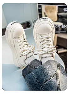 Detailed view of men's white leather platform sneakers with GAISIMA logo and thick laces.