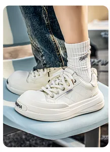 Macro view of beige leather sneakers with thick platform soles and cross stitching
