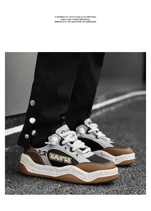 On-foot view of stylish chunky street sneakers with graffiti accents and thick laces