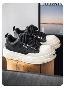Side view of black and white quilted leather platform sneakers on a wooden log.