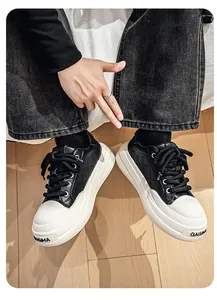 Detail view of men's black and white platform sneakers with quilted leather pattern