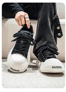 Close-up of black and white platform leather board sneakers with cross-pattern texture