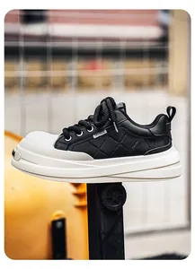 Detail view of black leather platform sneakers with quilted pattern and thick white sole