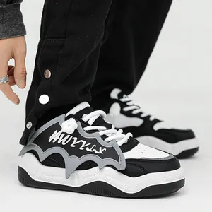 Stylish black and white chunky bread sneakers with unique grey bat wing side detail