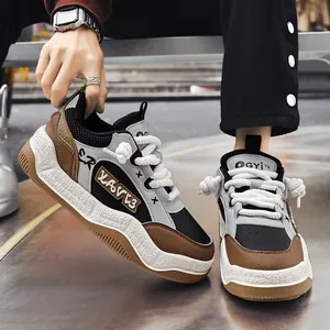 Stylish chunky platform sneakers for men with thick rope laces and graffiti detail.