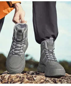 Durable waterproof grey tactical military boots for men in rugged outdoor terrain.