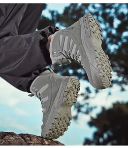 Dynamic low-angle detail of grey waterproof military combat boots for outdoor hiking