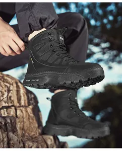 Close-up view of black tactical outdoor boots with thick soles for hiking and work.
