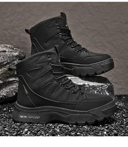 Detailed view of men's durable black tactical hiking boots on a rugged rocky ground